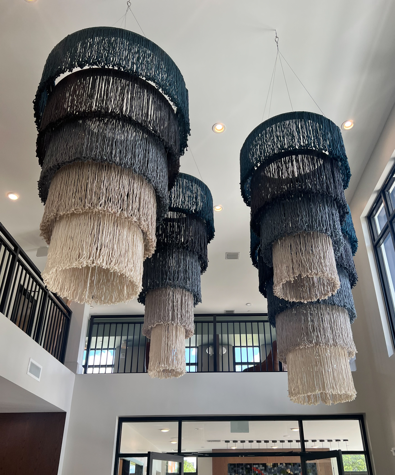 Installation view of large scale suspended string art sculptures in lobby space