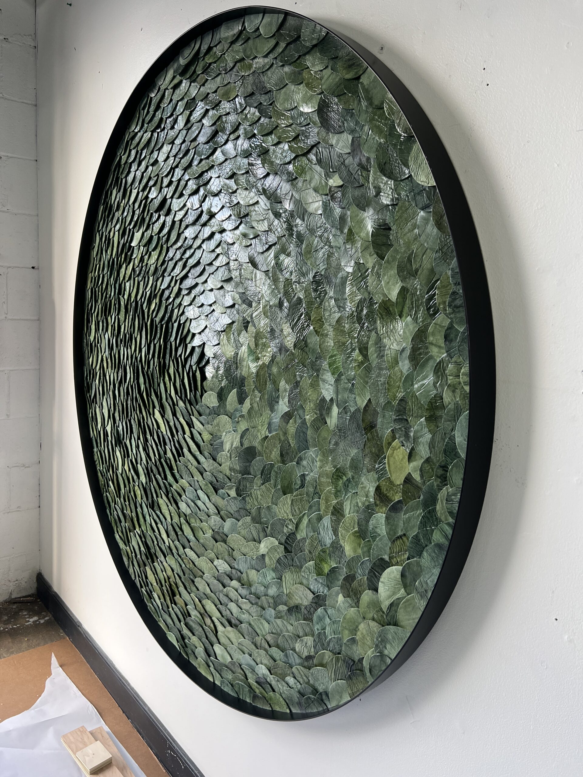 Custom Green Portal, paperclay assemblage with watercolor assemblage in black steel frame, 60” diameter, dimensional art for hotels and interiors