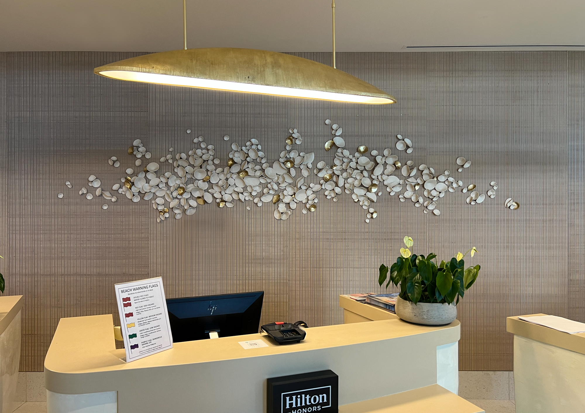 Installation view of custom paperclay cuppies in natural clay and metallic golds | Embassy Suites, Panama City Beach | approximately 36"H x 156"W