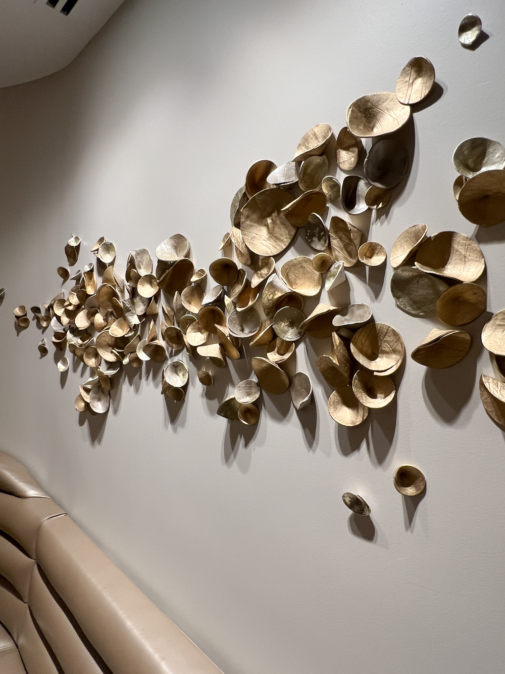 Direct to wall installation for Four Season Atlanta Spa, custom paperclay Cuppies in mixed metallics, approximately 18" x 72" area | Consulting by Canvas Atlanta