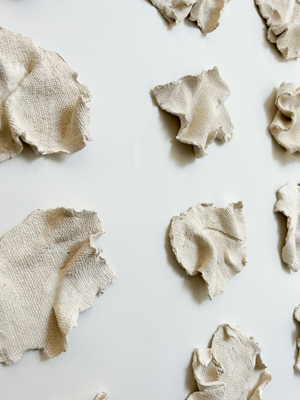 Custom Fabric Forma series on panel, free form paperclay elements with inlaid fabric patterning mounted to painted backer, 40.5" H x 52.5" W