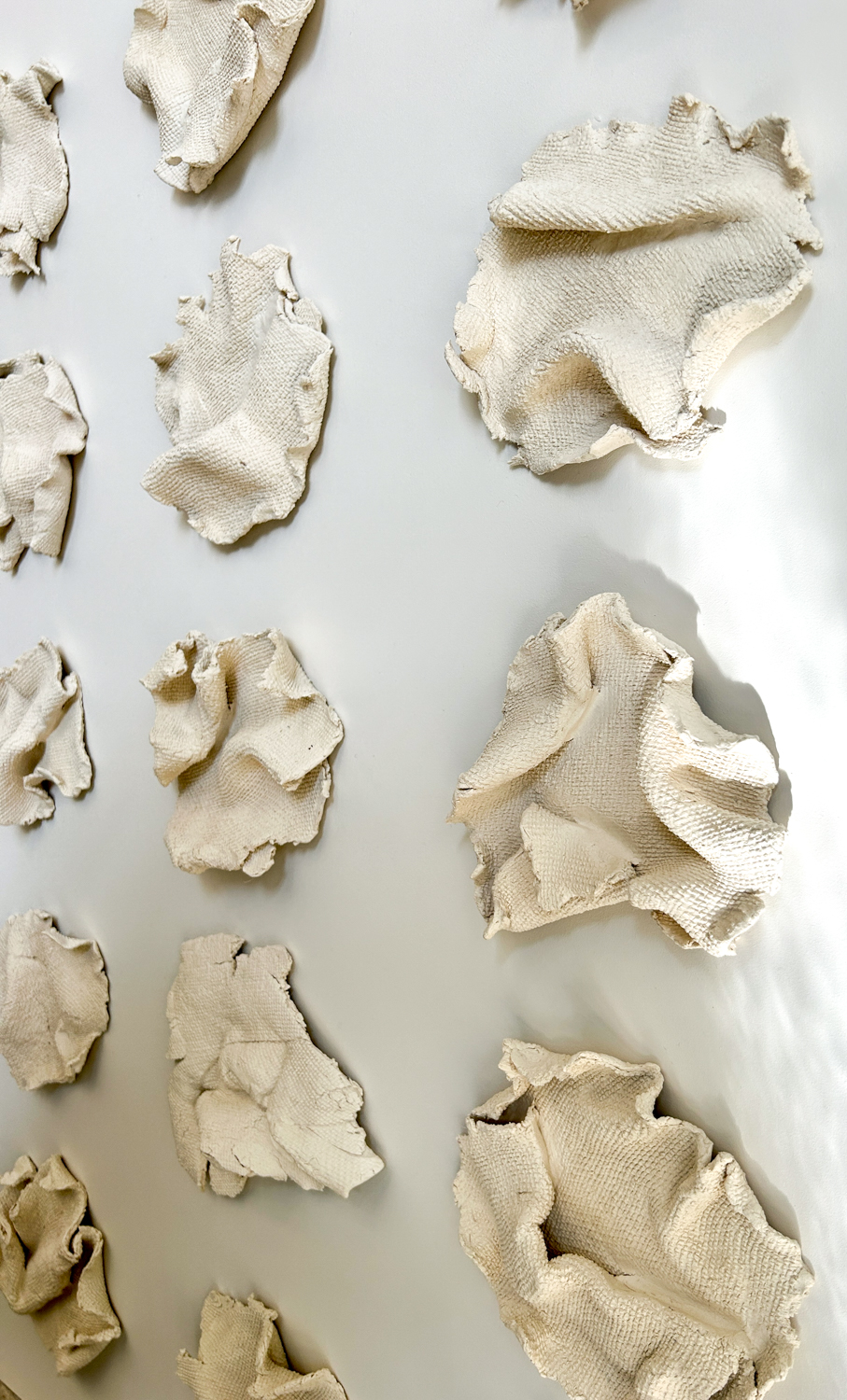 Custom Fabric Forma series on panel, free form paperclay elements with inlaid fabric patterning mounted to painted backer, 40.5" H x 52.5" W