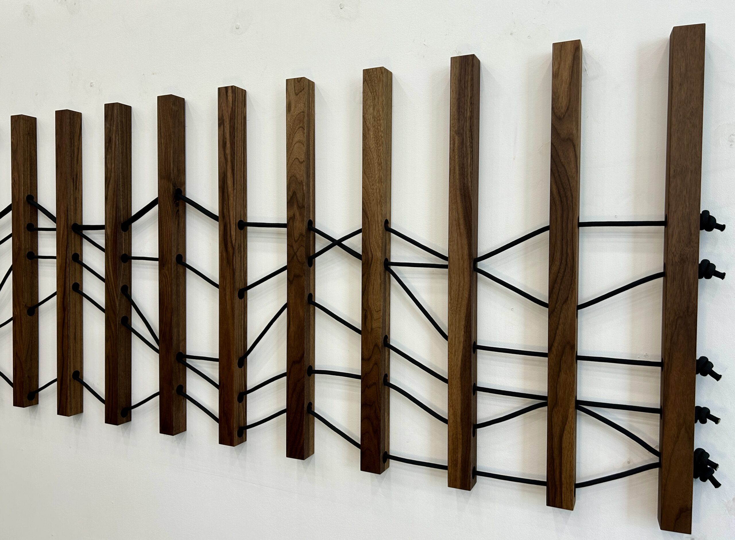 Emily Mann, Ink and Indigo, Wood + Woven Landscape 1, Custom Dimensional Wall Installation, Walnut Slats Woven through with Black Climbing Rope to represent Sedona Mountainscape, approximately 36h x 116w