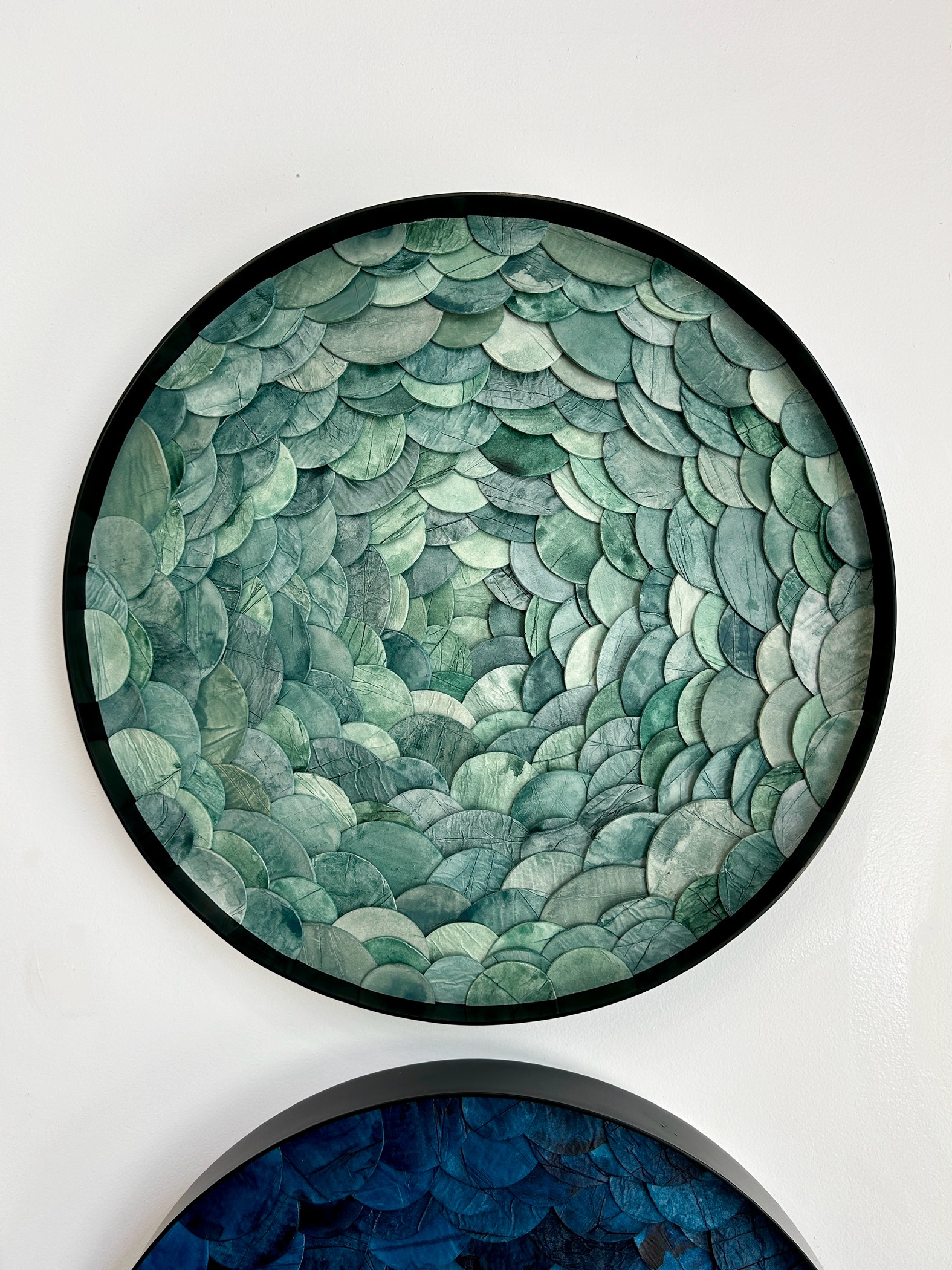 Custom dimensional wall art in Portal style, Japanese paperclay watercolor, mixed media in custom 24 " dia metal frame in black finish for hospitality project by Emily Mann of Ink and Indigo