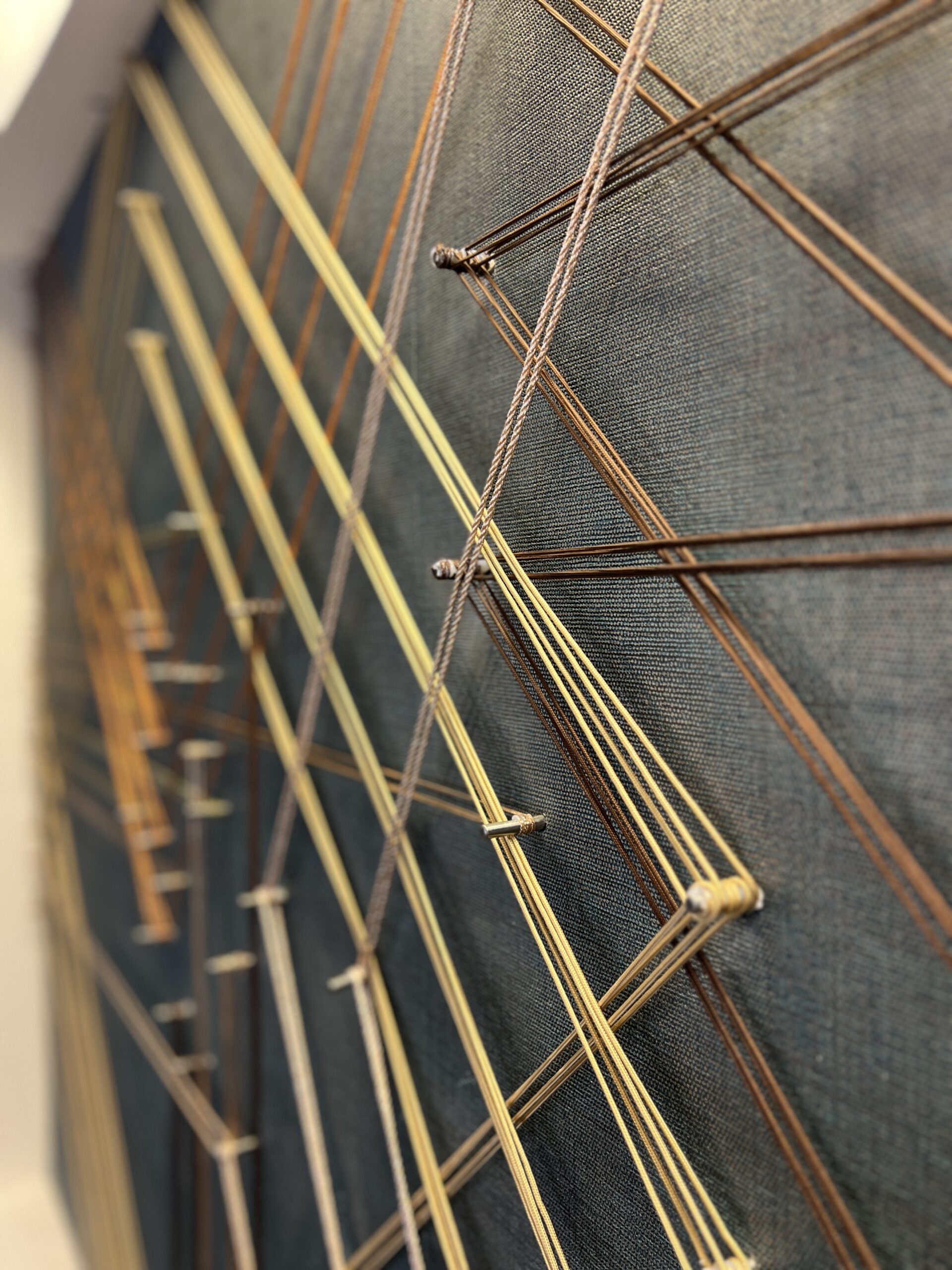 Custom Site Installation at the Georgia Tech Hotel + Conference Center Reception Desk, String, steel pegs, mixed media, 5’-2”H x 12’-2” W | Interior Design by TVS | Art Consulting by DAC