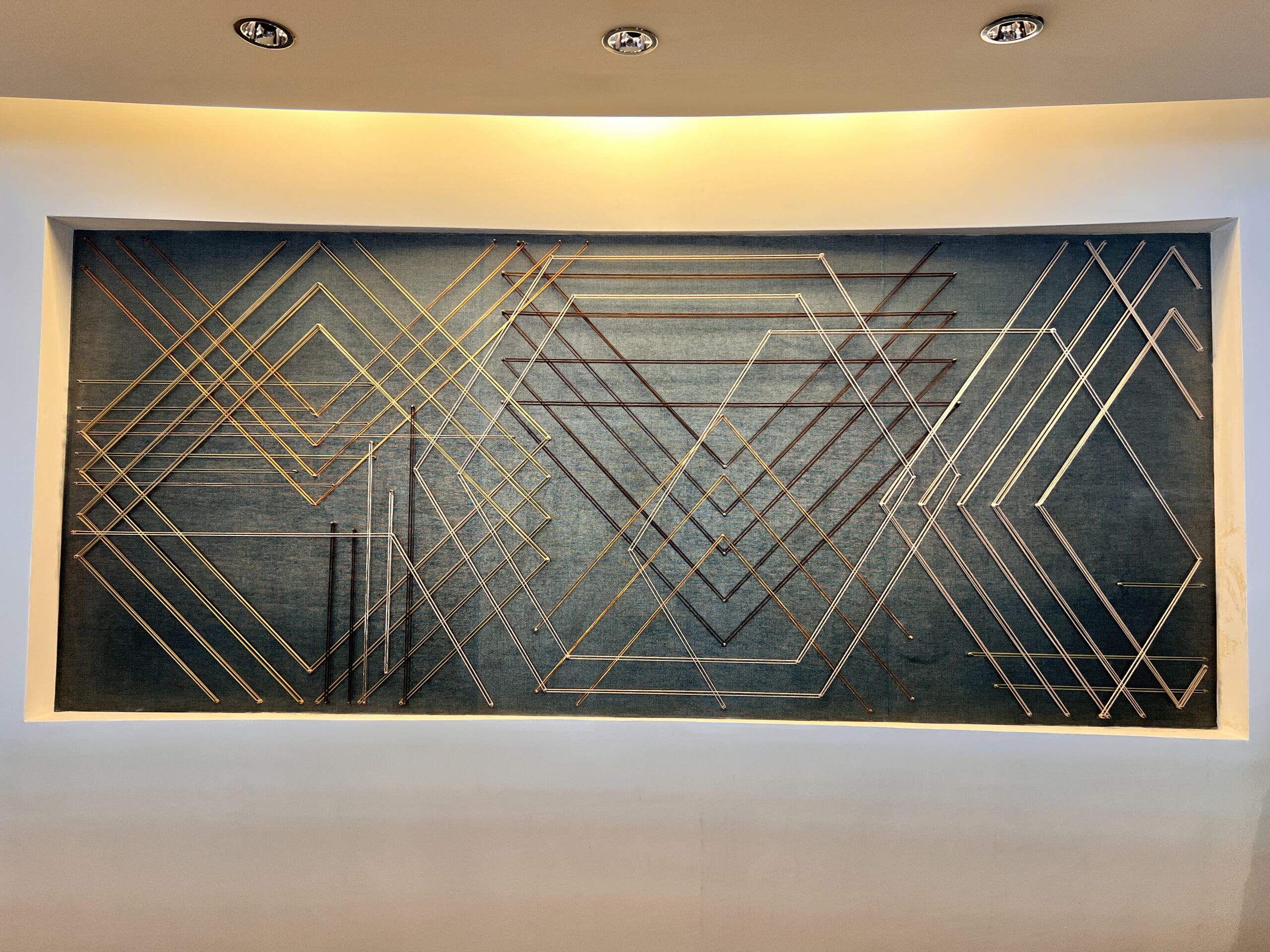 Custom Site Installation at the Georgia Tech Hotel + Conference Center Reception Desk, String, steel pegs, mixed media, 5’-2”H x 12’-2” W | Interior Design by TVS | Art Consulting by DAC